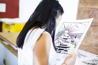Student considering art print